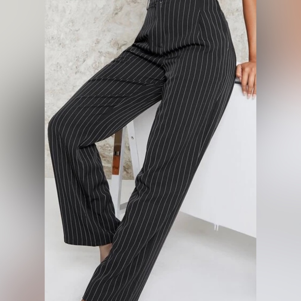 Size 11 black white pinstripe pants. Two back pockets. Great fit very slimming.